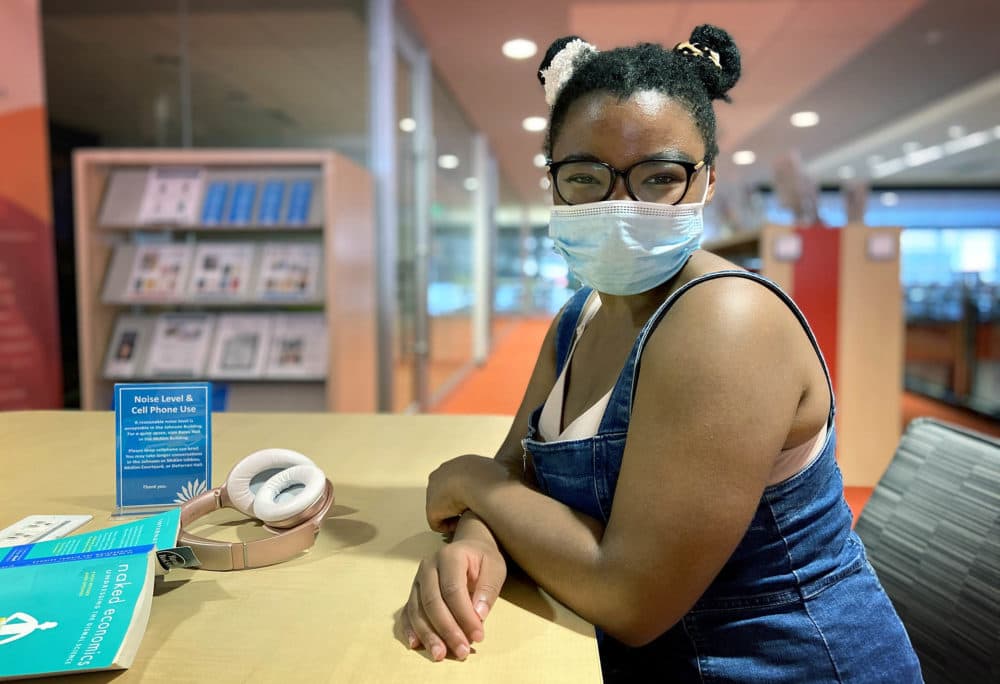 Rebecca Elliot took refuge from the heat at Boston Public Library as she awaited the delivery of an A/C unit. (Quincy Walters/WBUR)
