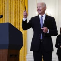 Vice President Kamala Harris watches as President Joe Biden takes a question from a reporter after speaking about distribution of COVID-19 vaccines, in the East Room of the White House, Monday, May 17, 2021, in Washington. (Evan Vucci/AP)