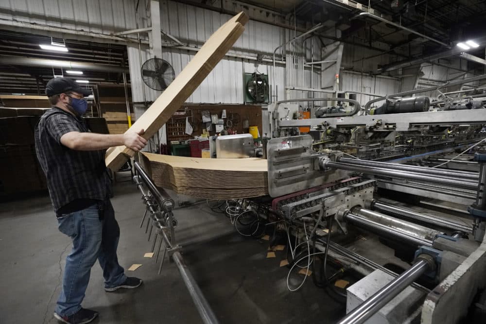 Rob Bondurant, a supervisor at Great Southern Industries, a packaging company, loads up a finishing machine in the Jackson, Miss., facility, May 28, 2021. The lack of workers has forced some supervisors to assume additional duties. (Rogelio V. Solis/AP)