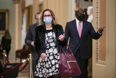 Sen. Kyrsten Sinema, D-Ariz., and Sen. Raphael Warnock, D-Ga., right, arrive at the Capitol in Washington. (J. Scott Applewhite, File/AP Photo)