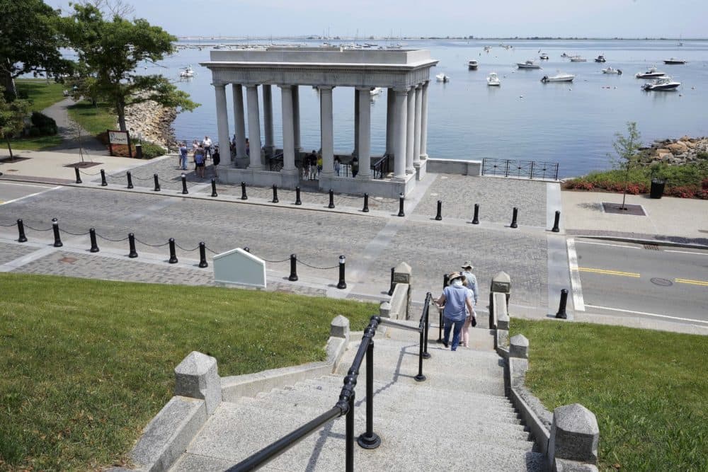 Pedestrians walk down stairs from Cole's Hill toward a pavilion that shelters Plymouth Rock. (Steven Senne/AP)