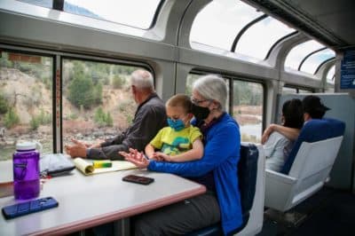Laurel MacBride holds her great-nephew, Rory Fuller, and sits next to her brother, Dexter MacBride, east of Grand Junction on the California Zephyr. (Stina Sieg/CPR News
Laurel MacBride holds her great-nephew, Rory Fuller, and sits next to her brother, Dexter MacBride, east of Grand Junction on the California Zephyr. (Stina Sieg/CPR News
Laurel MacBride holds her great-nephew, Rory Fuller, and sits next to her brother, Dexter MacBride, east of Grand Junction on the California Zephyr. (Stina Sieg/CPR)