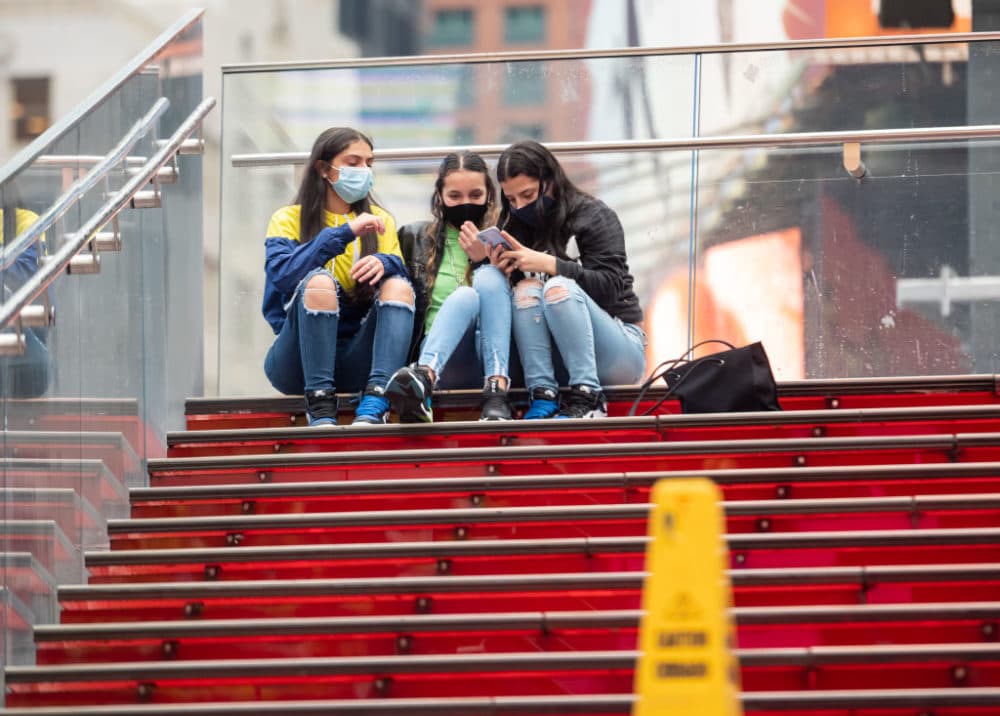 People wear face masks on the red steps in Times Square as the city continues the re-opening efforts following restrictions imposed to slow the spread of coronavirus on October 28, 2020, in New York City. (Photo by Noam Galai/Getty Images)