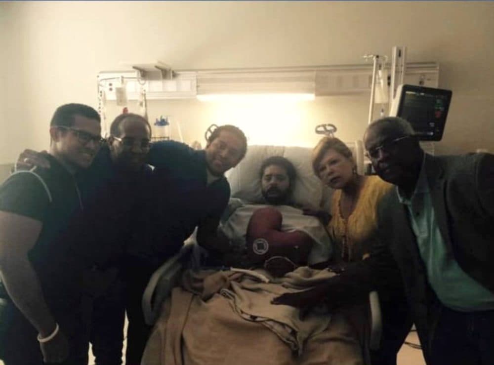 The Pean family gathers around Alan’s hospital bed at St. Joseph Medical Center in Houston, where he was shot by hospital security while in the grip of psychotic delusions. (Christian Pean)