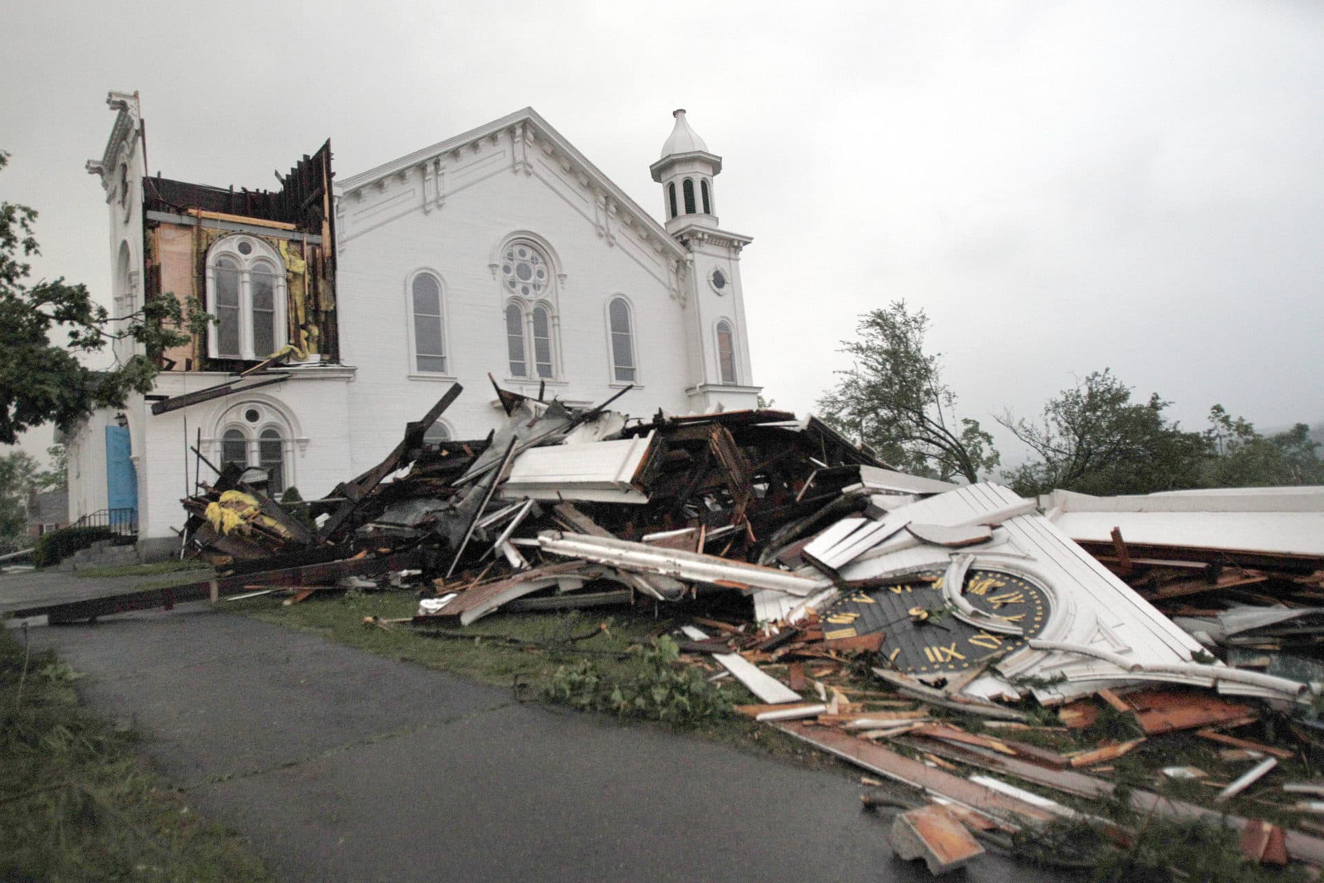 In this June 1, 2011 file photo, the steeple of The First Church of Monson, Mass., lies in rubble on the ground after the tornado blew through. (Elise Amendola/AP)