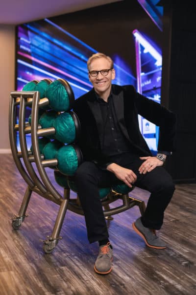 Artist John Carter sitting in his "Spare Chair" made out of bowling balls. (Courtesy Tamara Fleming)
