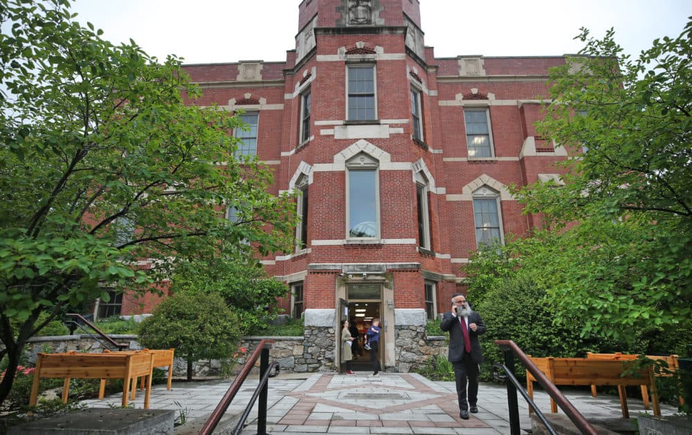 A man walks outside of Shaloh House, a Jewish day school on Chestnut Hill Avenue in Brighton. A rabbi was attacked outside of the school on July 1. (David L. Ryan/The Boston Globe via Getty Images)