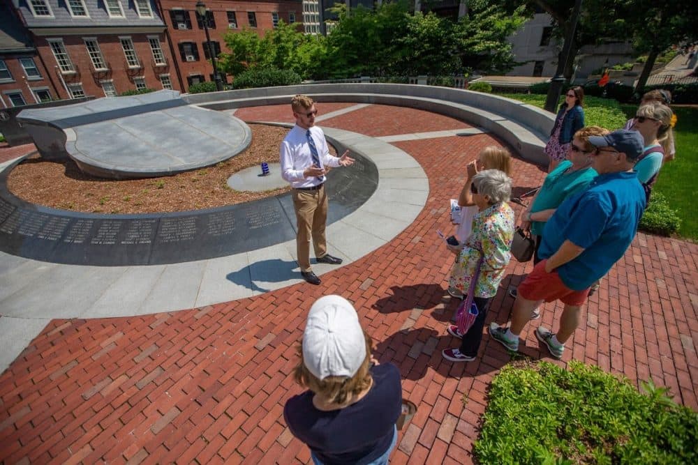 Suffolk University senior Alex Svenson talks about the Massachusetts Law Enforcement Memorial as he leads a small tour around the State House. (Jesse Costa/WBUR)