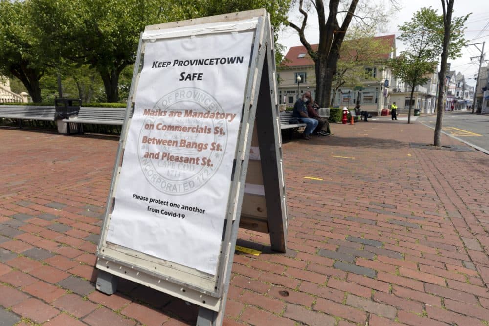 A sign advises that protective masks are required on the usually busy Commercial Street, May 25, 2020, in Provincetown, Mass. (Michael Dwyer/
AP)