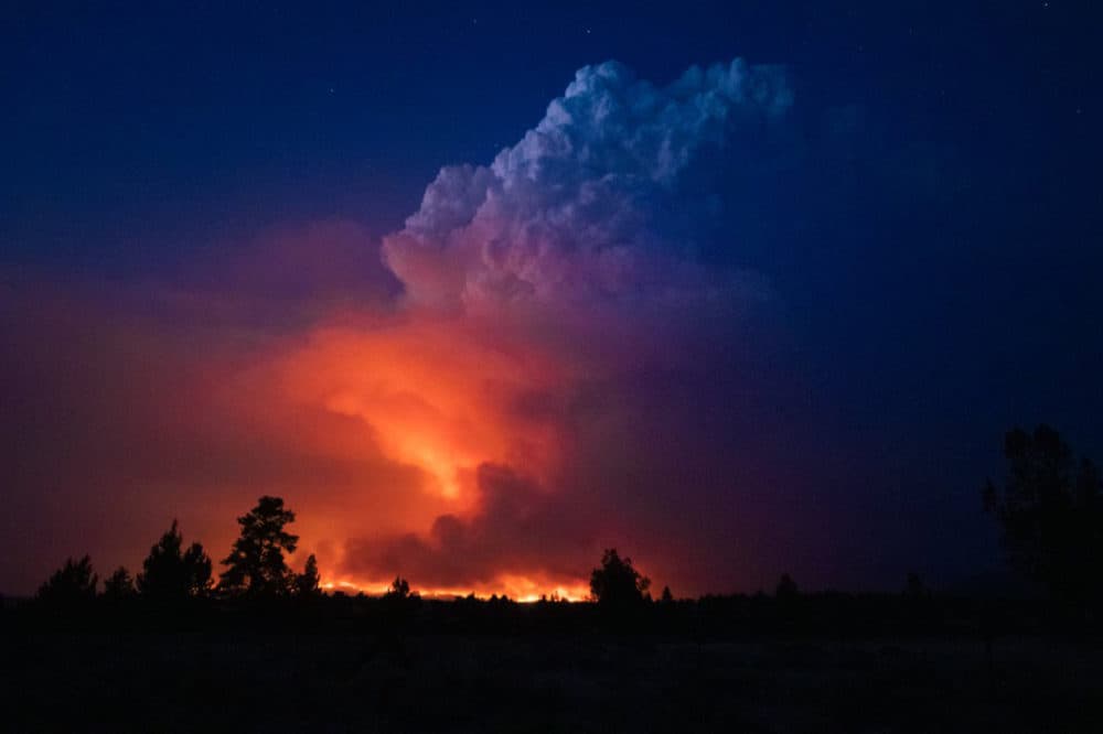 In this photo provided by the Oregon Office of State Fire Marshall, flames and smoke rise from the Bootleg Fire in southern Oregon on Wednesday, July 14, 2021. (John Hendricks/Oregon Office of State Fire Marshal via AP)