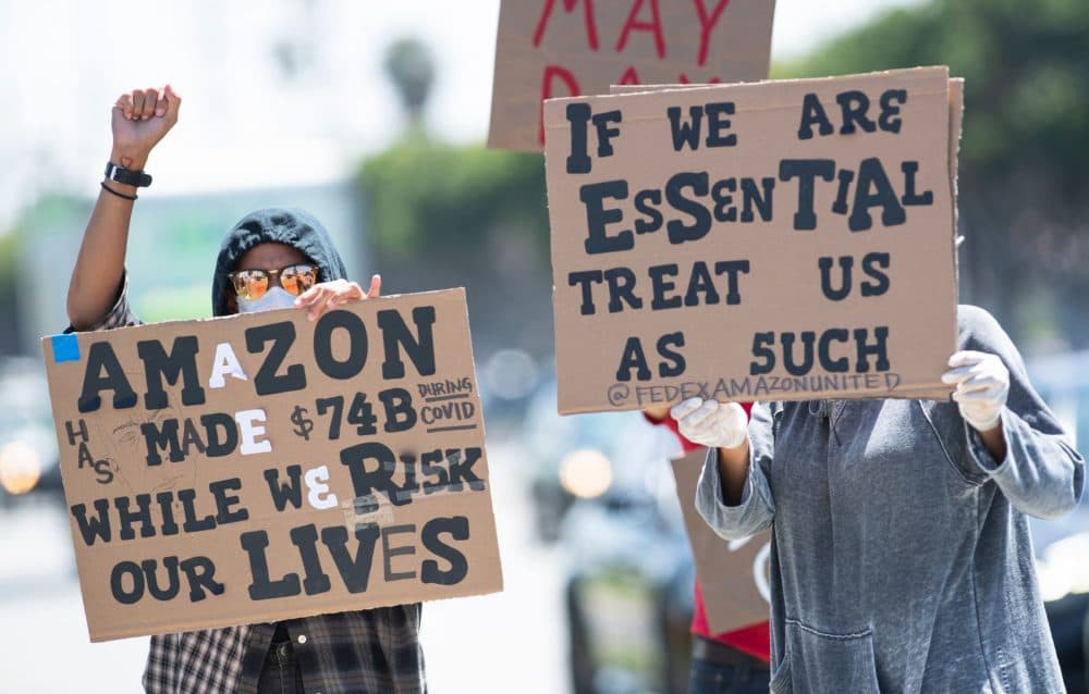 Workers protest against the failure to provide adequate protections, in May. (VALERIE MACON/AFP via Getty Images)