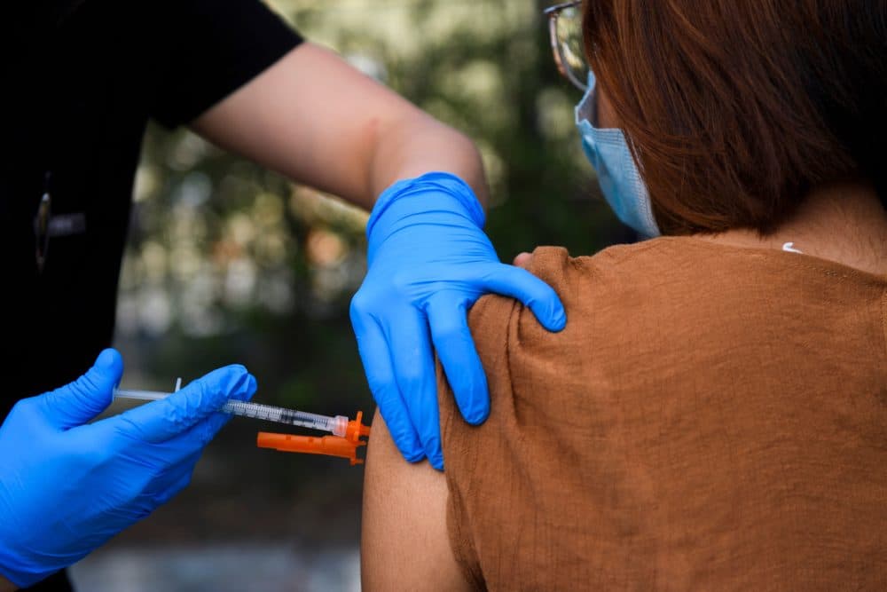 A 15-year-old receives a first dose of the Pfizer Covid-19 vaccine at a mobile vaccination clinic at the Weingart East Los Angeles YMCA on May 14, 2021 in Los Angeles, California. (Patrick T. Fallon/AFP via Getty Images)