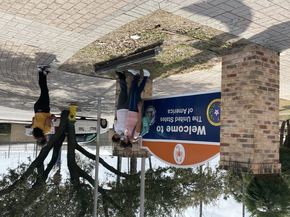 Nancy taking a picture on Feb. 28 in front of the welcome sign just outside the Brownsville, Texas port of entry. (Courtesy of Nancy)