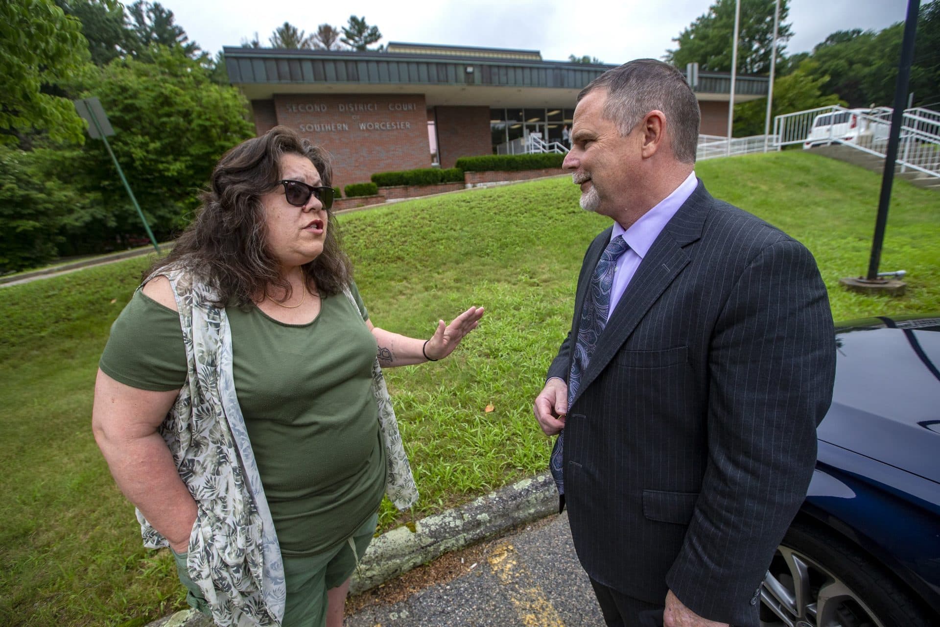 Laura Wojcechowicz speaking with her attorney Joseph Hennessey outside of the Second District Courthouse of Southern Worcester County in Uxbridge. (Jesse Costa/WBUR)