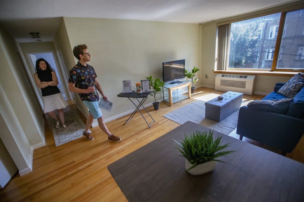Leon Vasershteyn walks into the living room as real estate agent Lourdes Hernández shows him around a condominium for sale in Brookline. (Jesse Costa/WBUR)