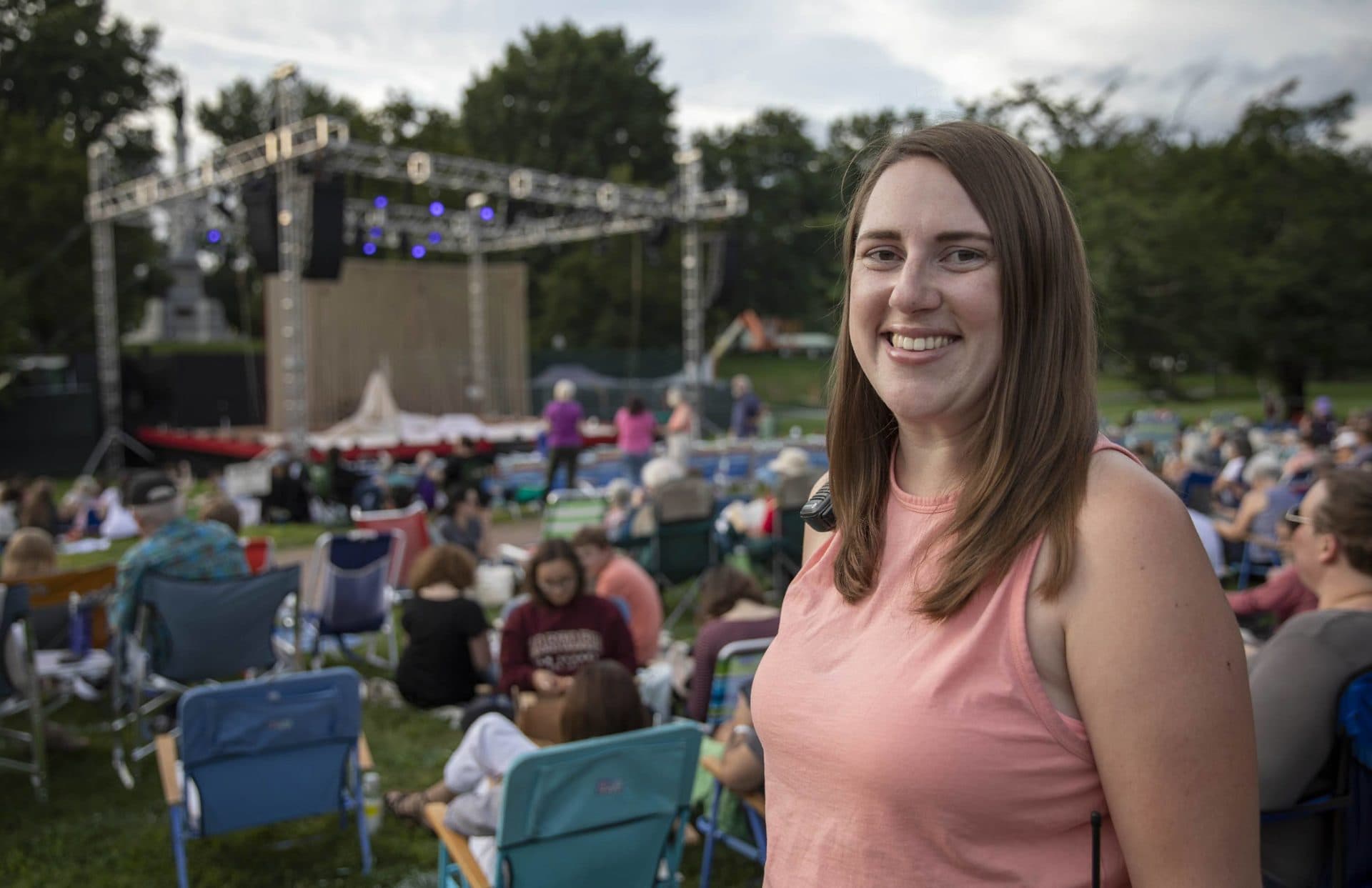 Jenna Worden, production manager of the Commonwealth Shakespeare Company's "The Tempest," near the stage on Boston Common as the audience starts to arrive. (Robin Lubbock/WBUR)