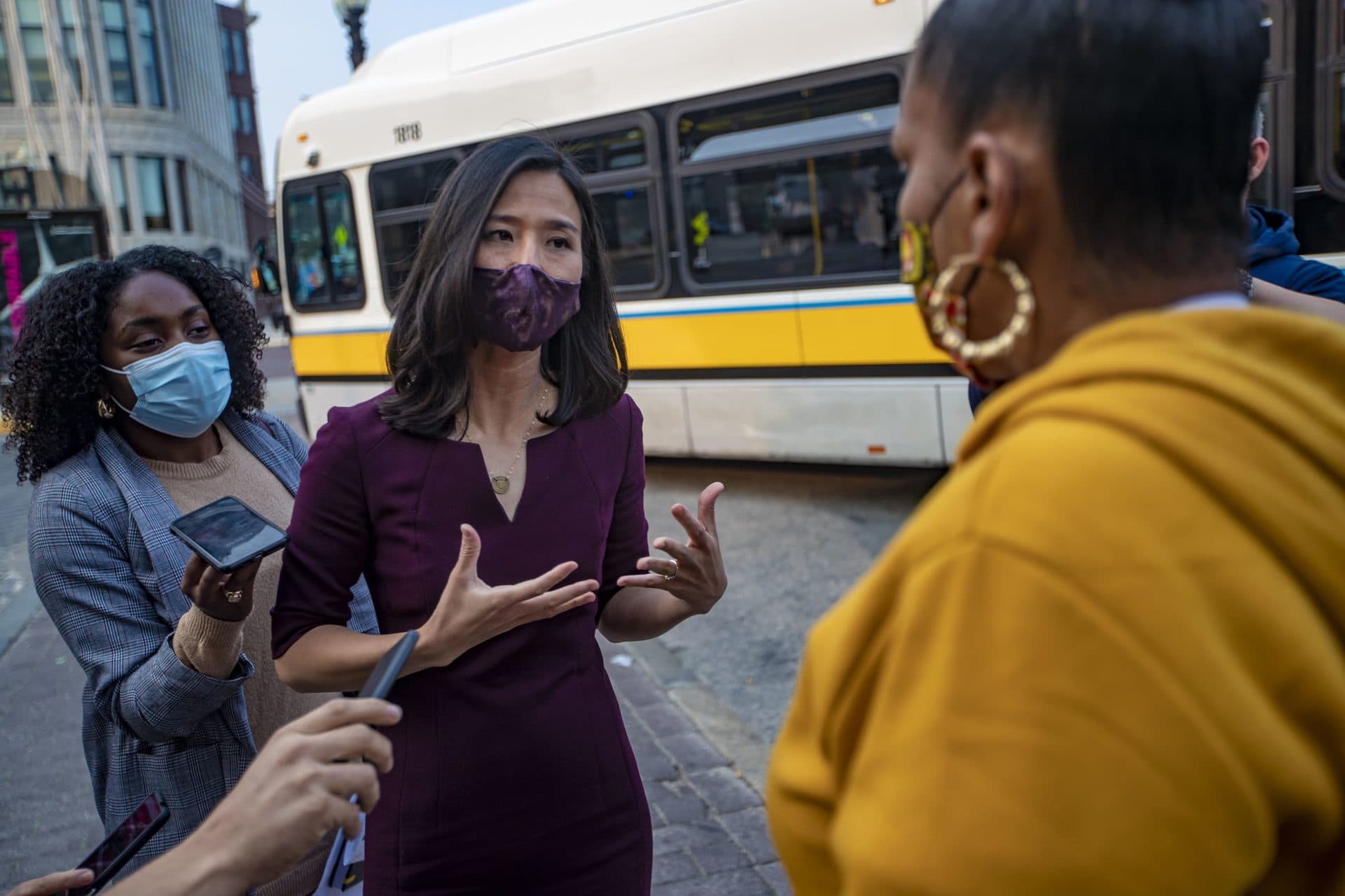 Mayoral candidate Michelle Wu speaks with a Roxbury resident during a campaign appearance outside of Nubian Station. (Jesse Costa/WBUR)