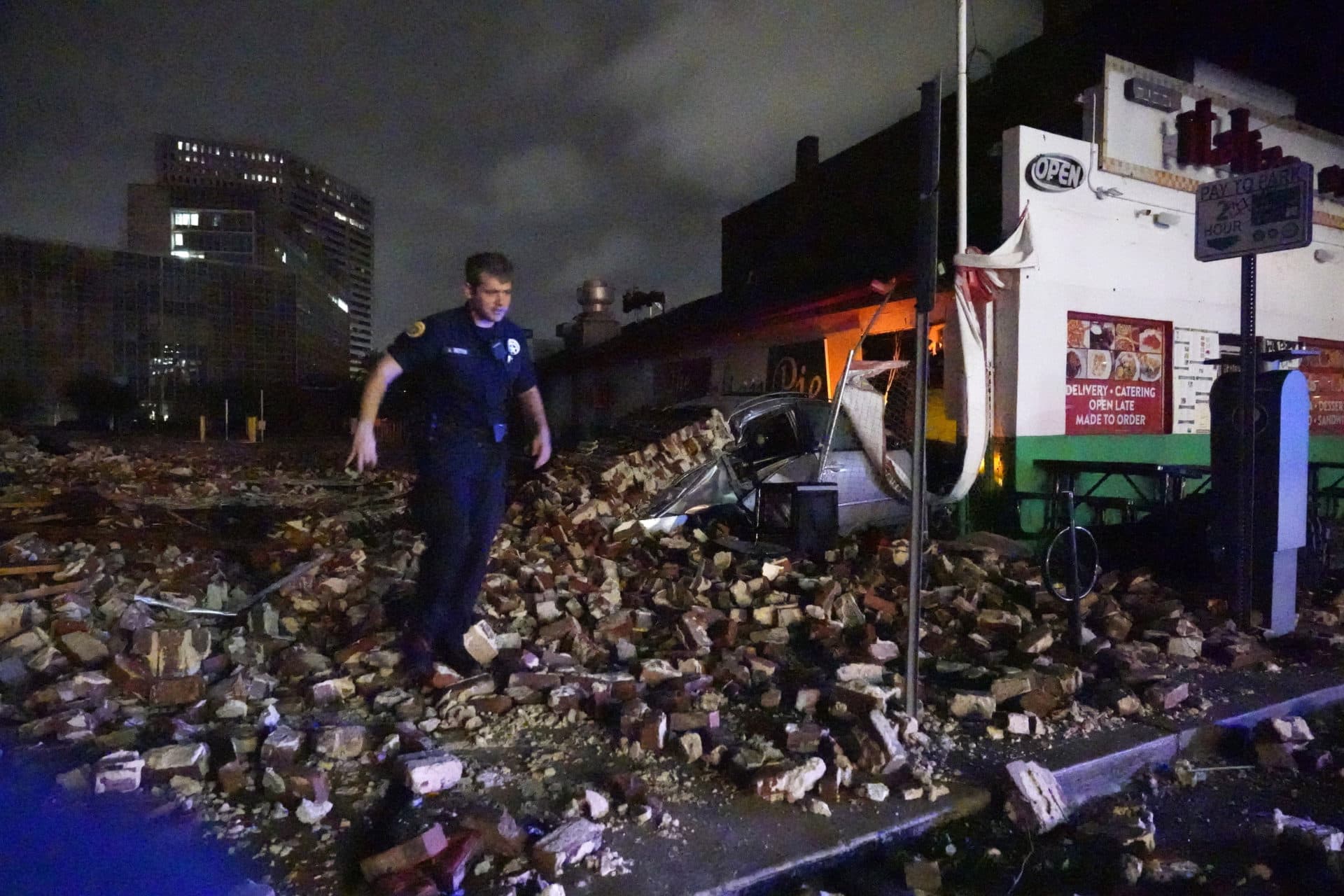 New Orleans Police detective Alexander Reiter, looks over debris from a building that collapsed during Hurricane Ida in New Orleans, Monday, Aug. 30, 2021. Hurricane Ida knocked out power to all of New Orleans and inundated coastal Louisiana communities on a deadly path through the Gulf Coast that is still unfolding and promises more destruction. (Gerald Herbert/AP Photo)