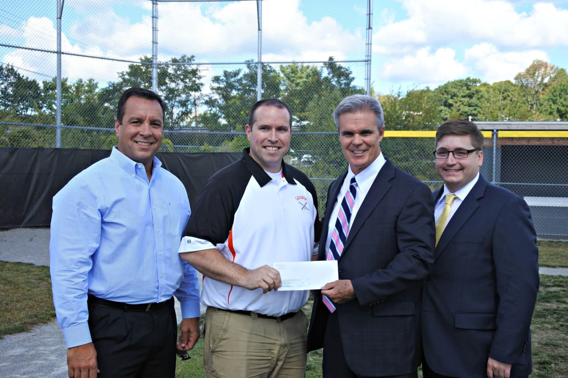 District Attorney Joseph D. Early Jr. presents a check from his county's drug forfeiture funds to Gardner Youth Baseball & Softball League to help improve their field. The league’s president, Kevin Robillard, accepted the check and they were joined by former Gardner Mayor Mark Hawke and state Rep. Jonathan Zlotnik. (Photo published on Worcester County District Attorney's Office website in 2016)