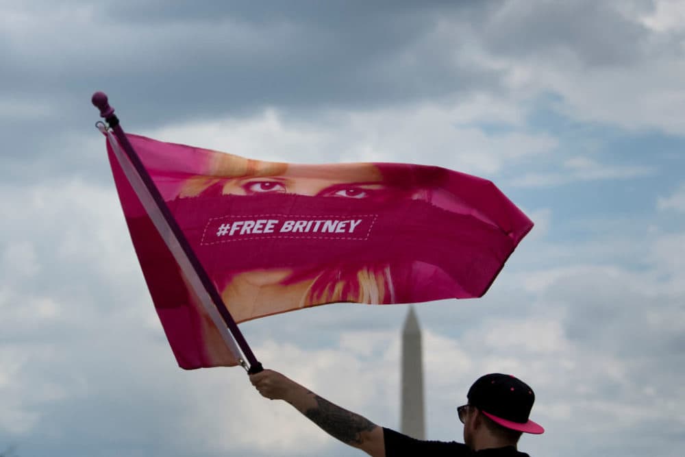 A man waves a "Free Britney" flag during a rally in front of the Lincoln Memorial protesting the conservatorship of Britney Spears on July 14, 2021, in Washington, D.C. (Brendan Smialowski/AFP/Getty Images)