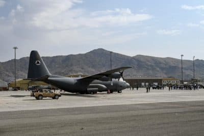 Taliban Badri special force fighters stand guard next to a Afghan Air Force aircraft at the airport in Kabul (Wakil Kohsar/Getty Images)