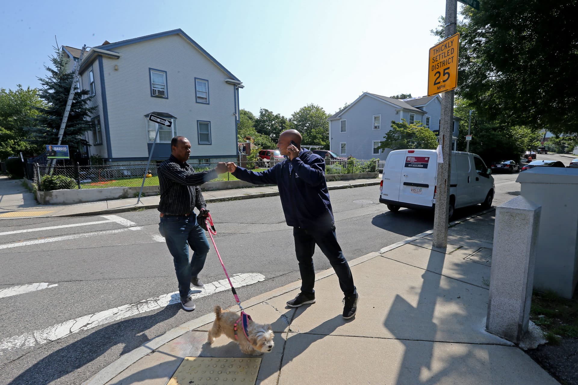 Mayoral candidate John Barros is greeted by a supporter as he walks in Roxbury. (Stuart Cahill/MediaNews Group/Boston Herald via Getty)