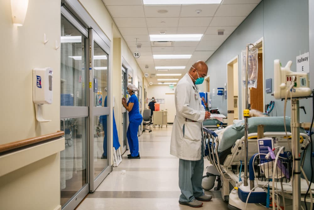 Dr. Michael Nguyen tends to a patient in a hallway at the Houston Methodist The Woodlands Hospital on August 18, 2021 in Houston, Texas. (Brandon Bell/Getty Images)