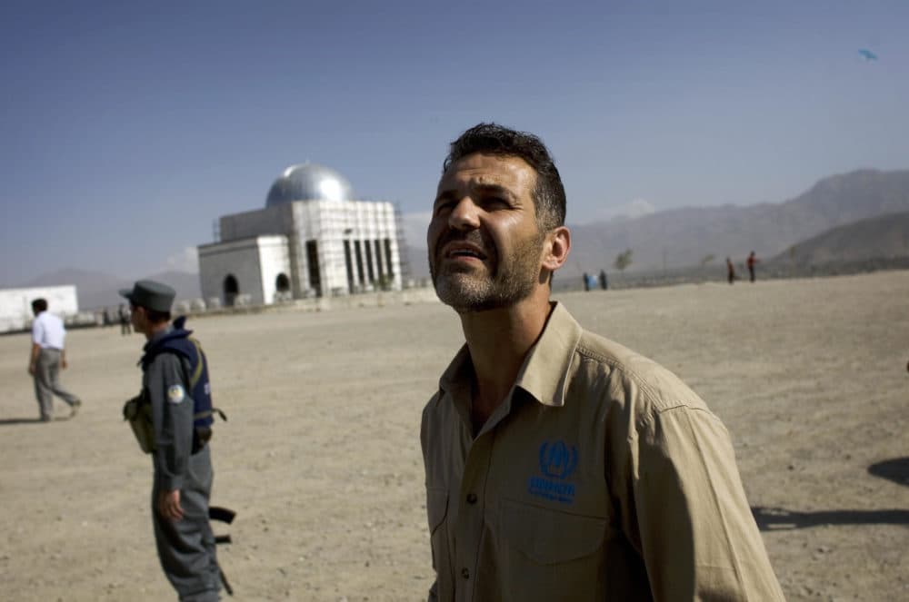 Afghan-American author Khaled Hosseini watches Afghan boys fly kites during a United Nations sponsored visit in Kabul on September 14, 2009. Hosseini, the Afghan-American author of bestselling novel "The Kite Runner", flew kites with boys on a Kabul hilltop, hailing development as the key to crushing Taliban rebels. (David Furst/AFP via Getty Images)