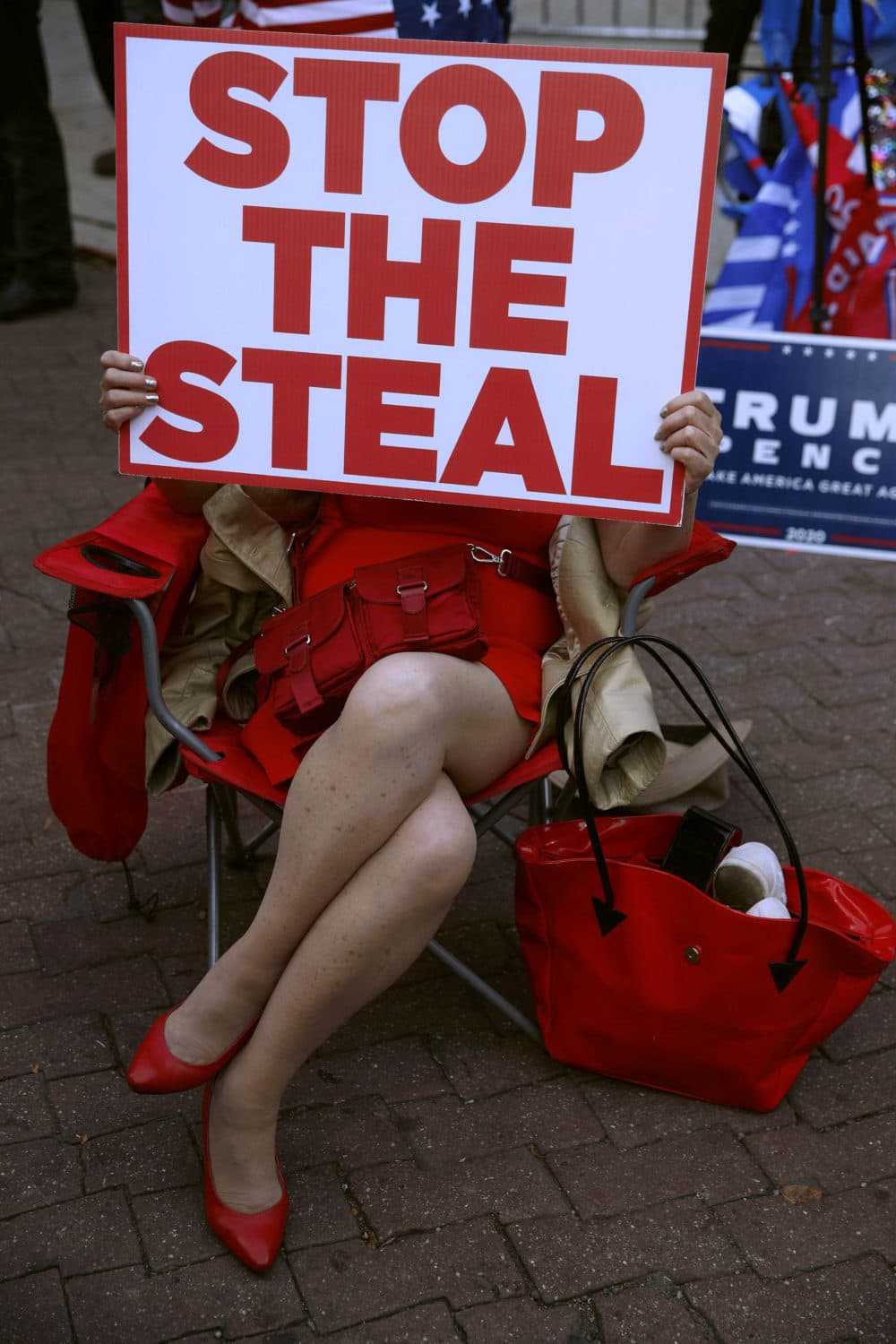 A demonstrator supporting former President Trump holds a sign that says, "Stop the steal" outside the Pennsylvania Convention Center where votes are being counted on Nov. 6, 2020, in Philadelphia. (Rebecca Blackwell/AP)