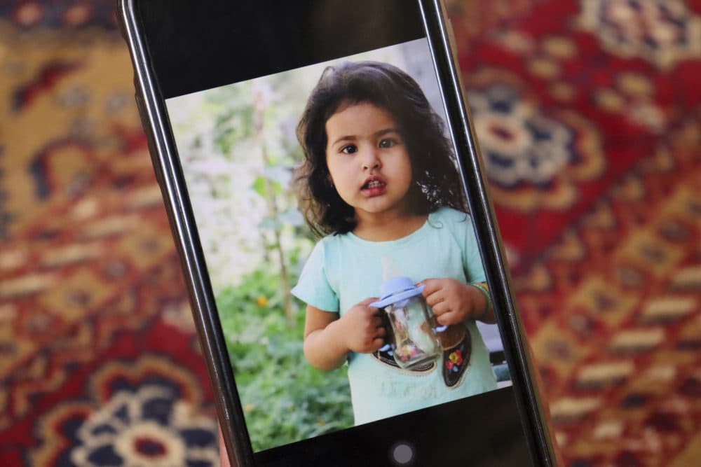 Emal Ahmadi shows a photo of his family member who was killed during a U.S. drone strike on their home, in Kabul, Afghanistan, Sept. 2, 2021. Ahmadi says Sunday's U.S. drone strike killed 10 members of his family, six of them children. Senior U.S. military officials said the drone strike hit an Islamic State target. (Khwaja Tawfiq Sediqi/AP)
