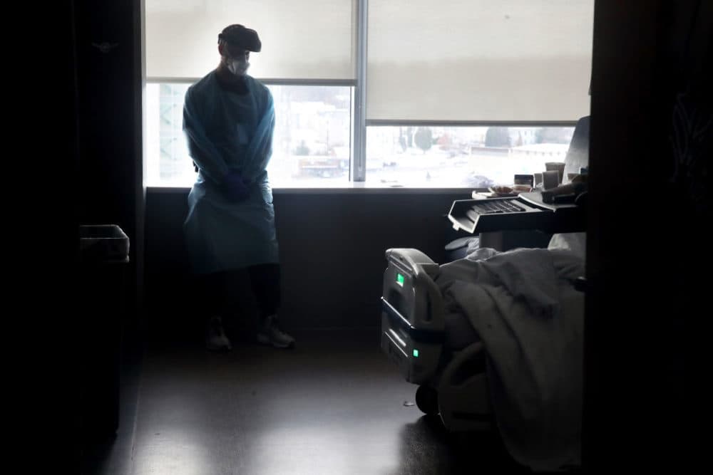 Physicians assistant Brendan Smith cares for a patient in a COVID unit at UMass Memorial Medical Center in Worcester, Mass. on December 10, 2020. (Craig F. Walker/The Boston Globe via Getty Images)