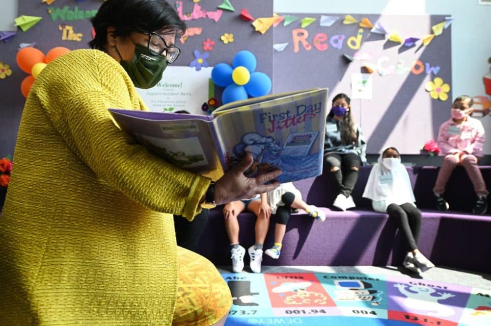 Los Angeles Unified School District (LAUSD) interim Superintendent Megan Reilly reads a book called "First Day Jitters" to students in the library at Kim Elementary School on the first day of the school year, in Los Angeles, California, August 16, 2021. (Robyn Beck/AFP/Getty Images)