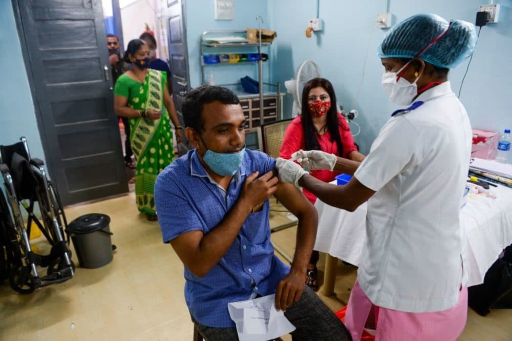 A health worker inoculates a man with a dose of the Covishield COVID-19 coronavirus vaccine in a hospital in Mumbai on Sept. 21, 2021. (Indranil Mukherjee/Getty Images)