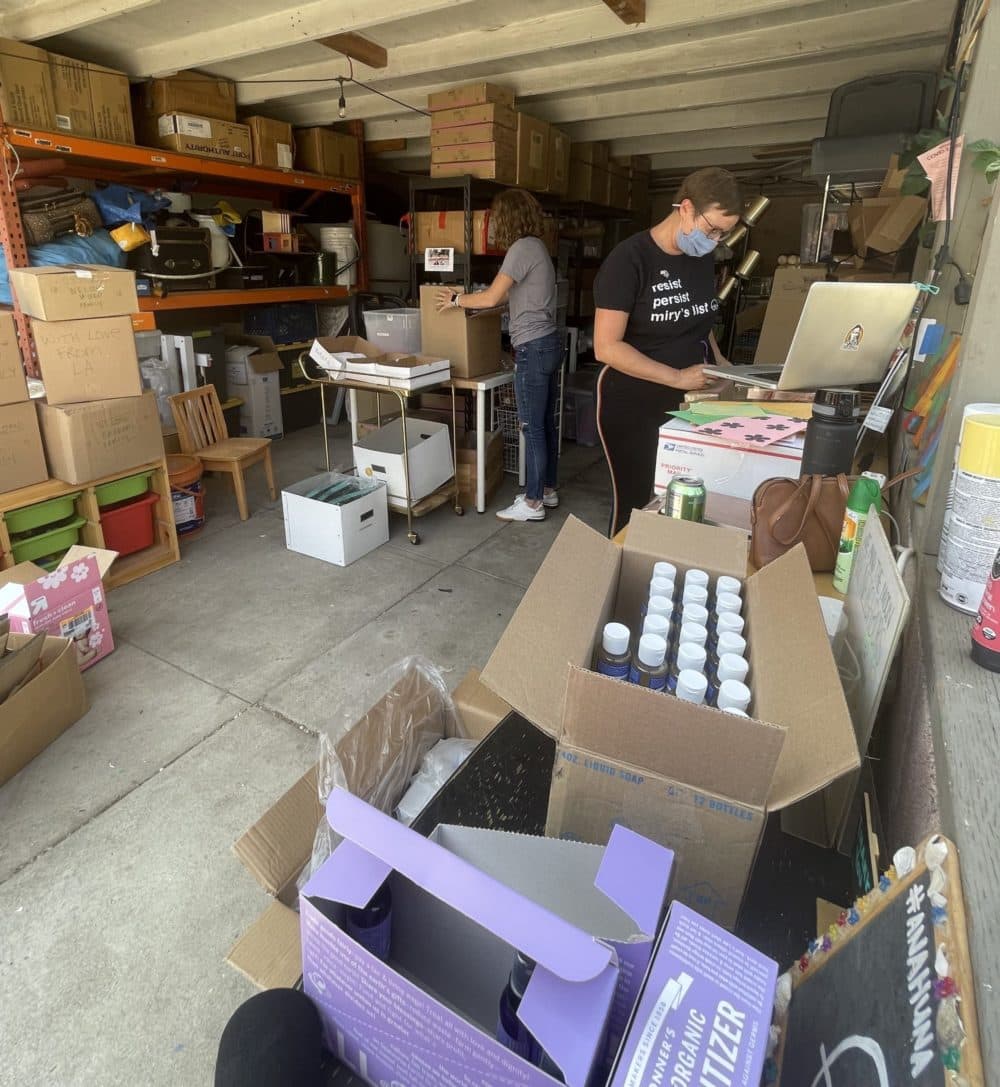 Miry's List founder Miry Whitehill and volunteer Krysta Masciale assemble care packages for new Afghan refugees arriving in the U.S. (Tonya Mosley/Here & Now)