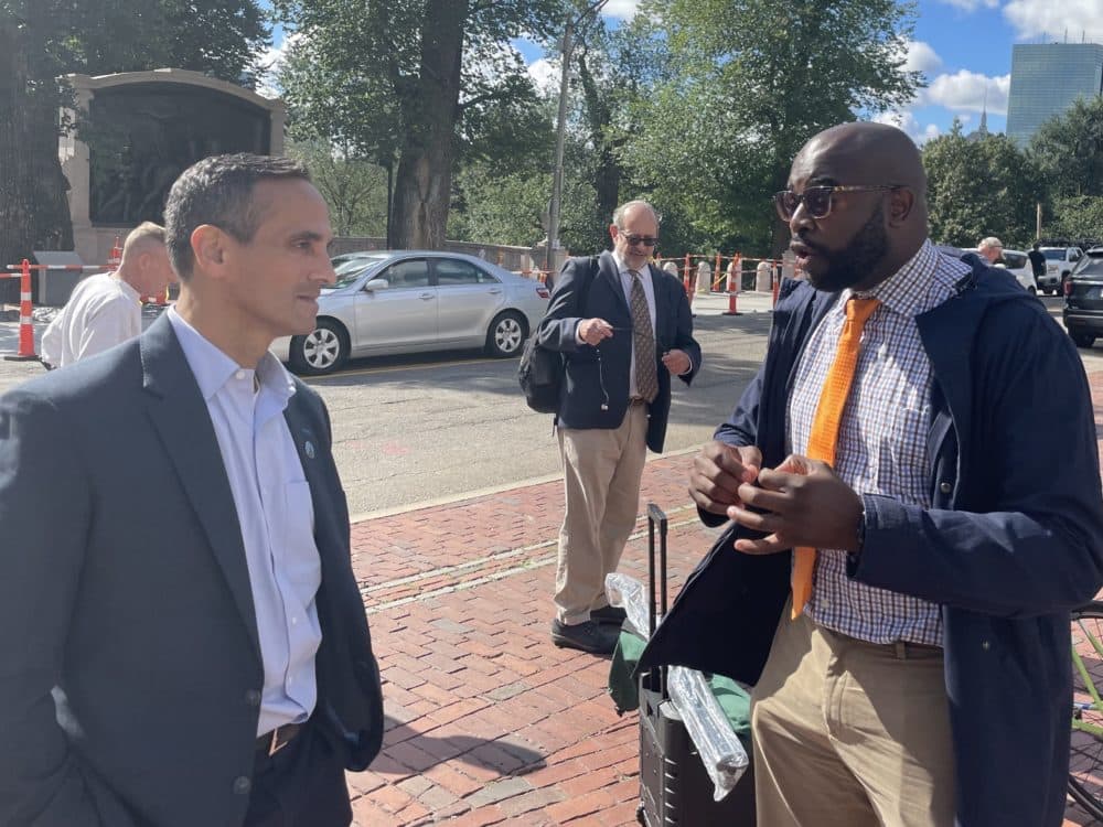 Mayor of Somerville Joe Curtatone and Jarred Johnson of TransitMatters both spoke at the rally for more MBTA funding and oversight. (Darryl C. Murphy/WBUR)