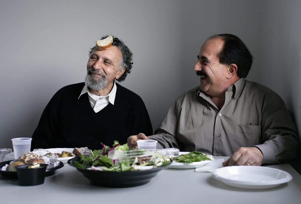 Tom and Ray Magliozzi, better known as "Click and click," the co-hosts of the national syndicated talk show, "Car Talk." Here they have lunch with members of their production team after a recording session on 22 December 2004 at WBUR.  (Dina Rudick / The Boston Globe via Getty Images)