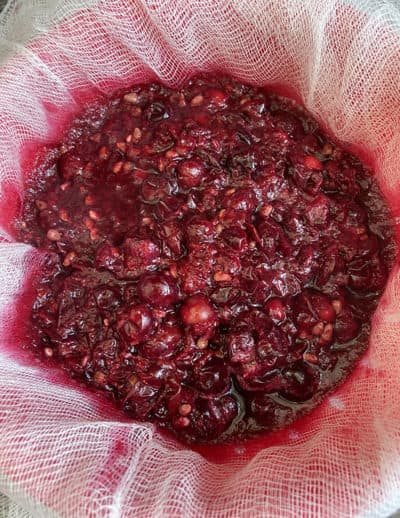 Straining the Concord grape jelly (Kathy Gunst)