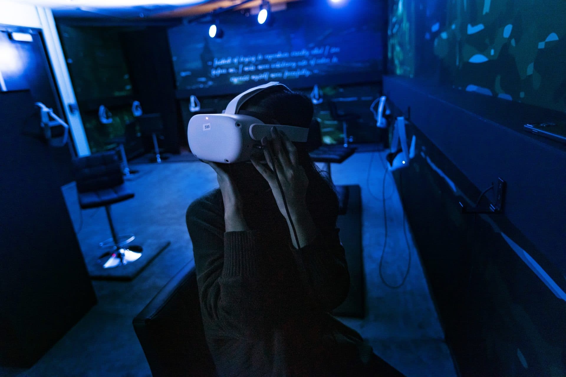 WBUR’s Magdiela Matta wears a VR headset to watch the Virtual Reality interactive portion of "Van Gogh: The Immersive Experience," which guides you on a 10-minute journey through a day in the life of the artist. (Jesse Costa/WBUR)