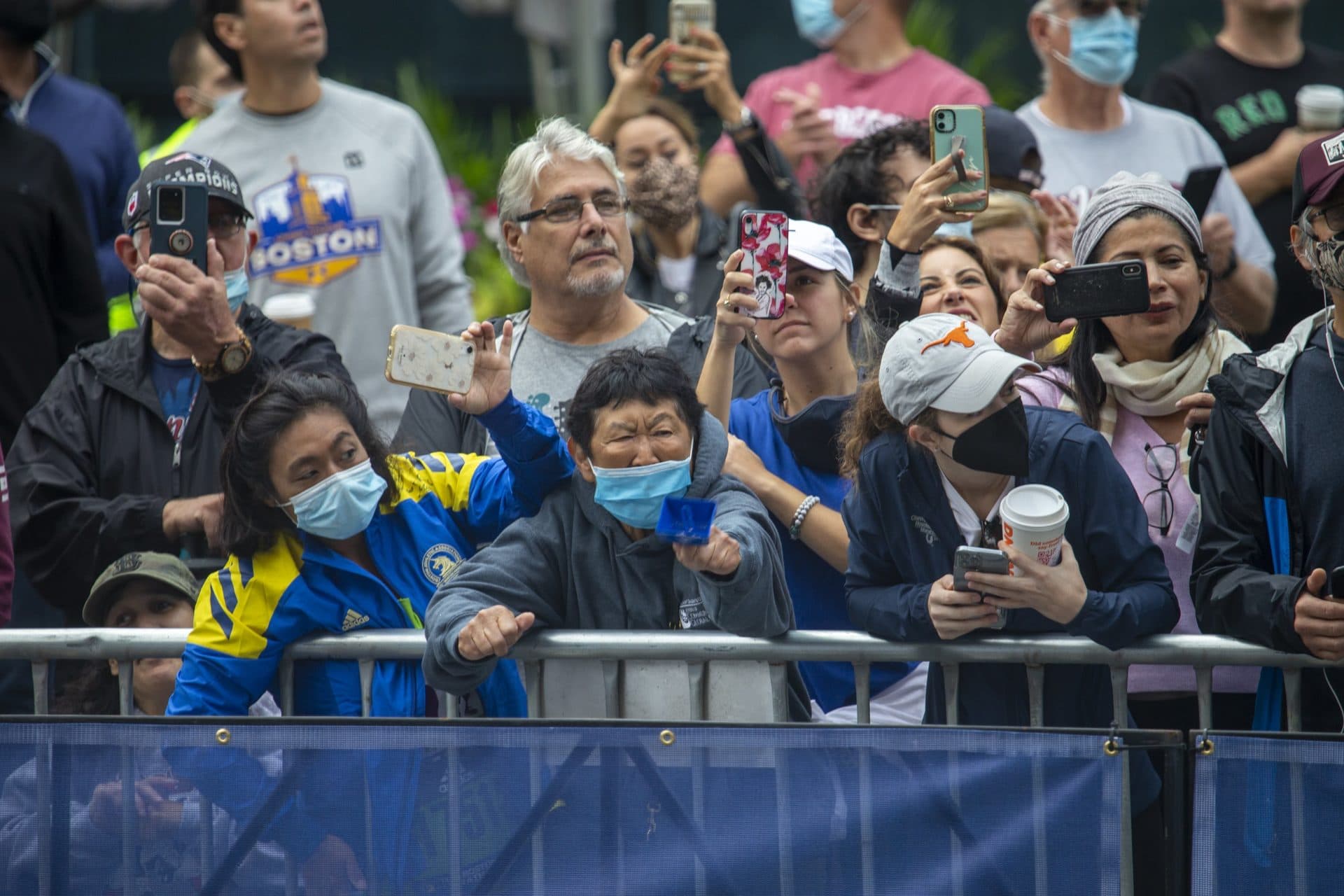 Spectators at the Boston Marathon cheer along Boylston Street as racers approach the finish line. (Jesse Costa/WBUR)