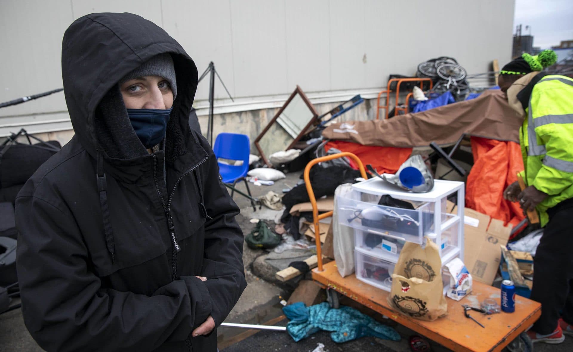 Samantha Kardas sorted through her storm-damaged shelter before a BPHC crew cleared it away. (Robin Lubbock/WBUR)