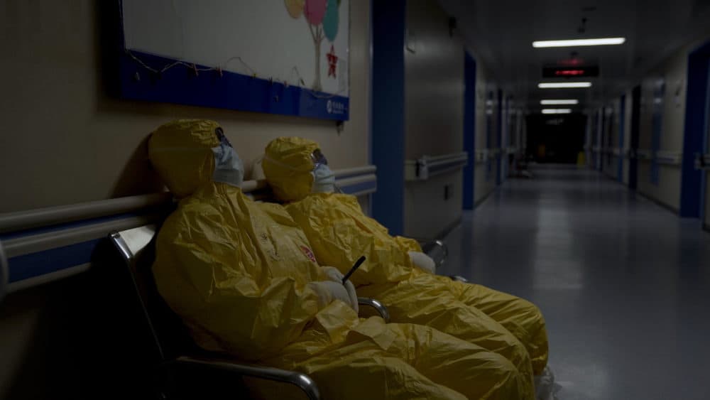 Nurses collapse from exhaustion in a hospital hallway during the peak of the COVID-19 outbreak in Wuhan, China. Seen in "76 Days." (MTV Documentary Films)