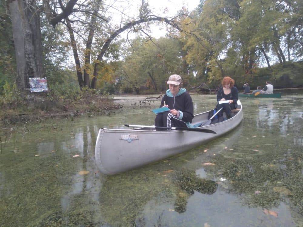 In a cove on the Connecticut River in Northampton, Massachusetts, art viewers paddled through "Swamp Show," an exhibit of art inspired by nature. Along with life vests, participants were given a prompt to write or draw while out on the oxbow. (Jill Kaufman/NEPM)