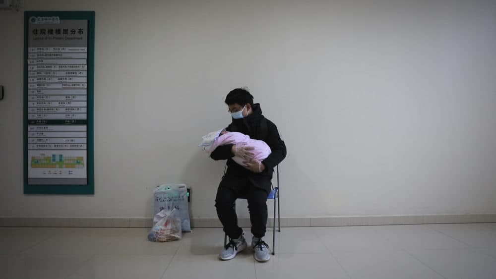 Father holds his newborn baby in hospital during the peak of the COVID-19 outbreak in Wuhan, China. Seen in "76 Days." (MTV Documentary Films)