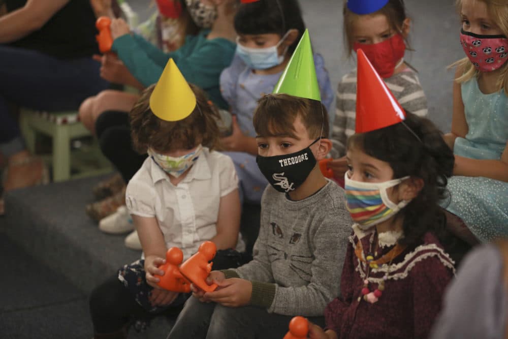 Children wait for Gov. Michelle Lujan Grisham to make an announcement about child care subsidies on Thursday, July 1, 2021, in Santa Fe, N.M. (Cedar Attanasio/AP)