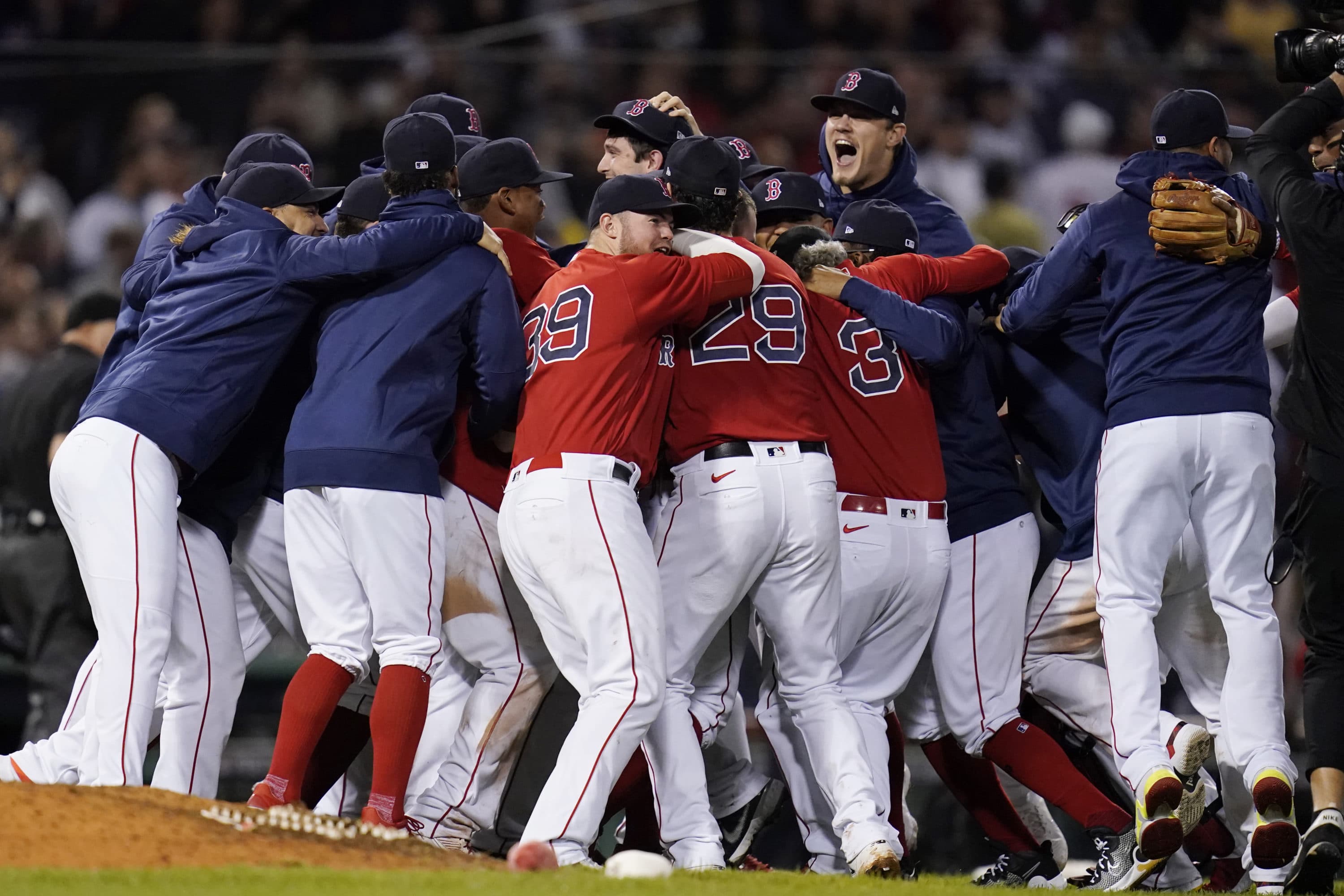 The Boston Red Sox celebrate after they defeated the New York Yankees 6-2 in an American League Wild Card playoff baseball game at Fenway Park, Tuesday, Oct. 5, 2021, in Boston. (Charles Krupa/AP)