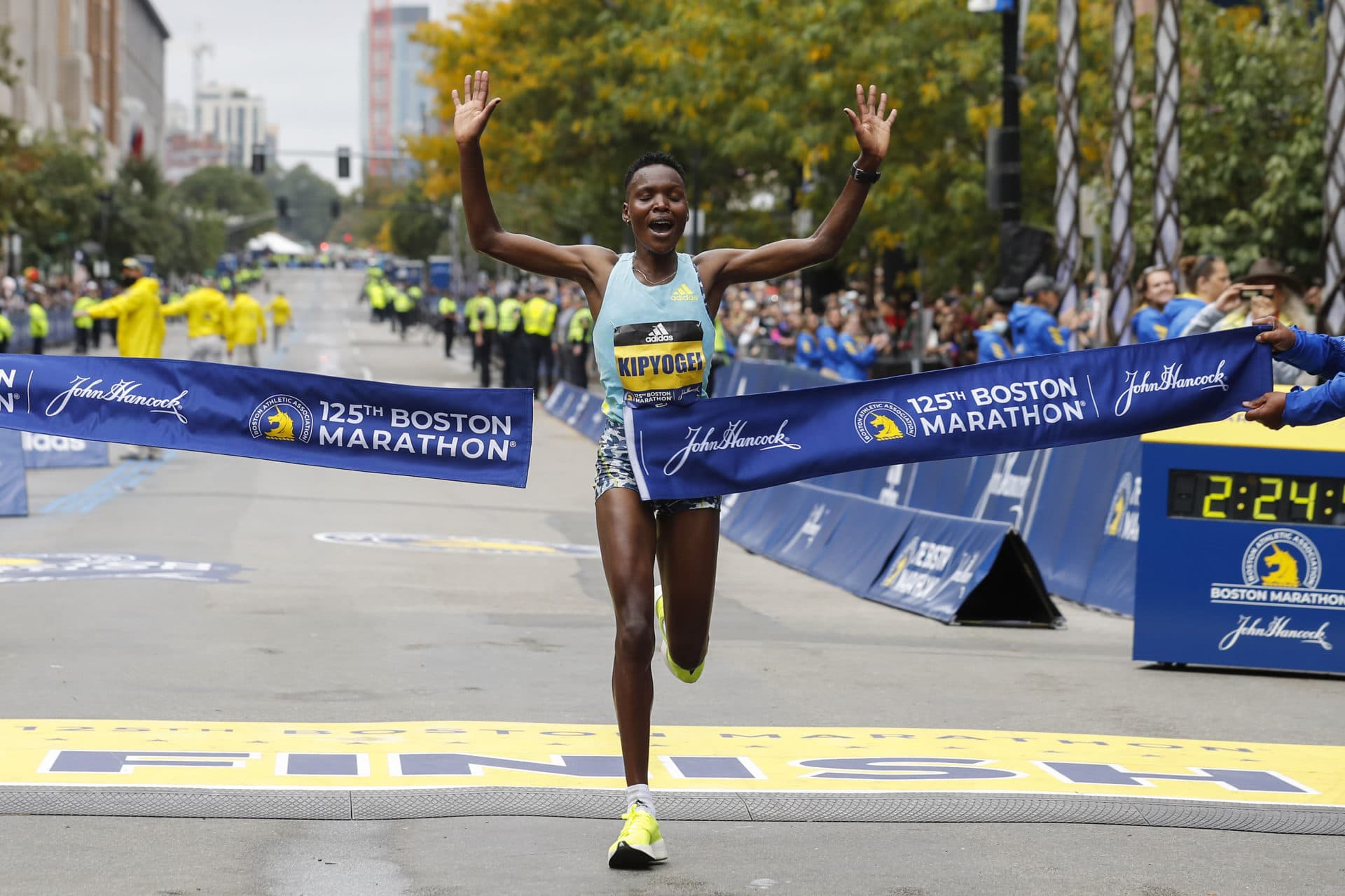 Diana Kipyogei, of Kenya, hits the tape to win the women's division. (Winslow Townson/AP)