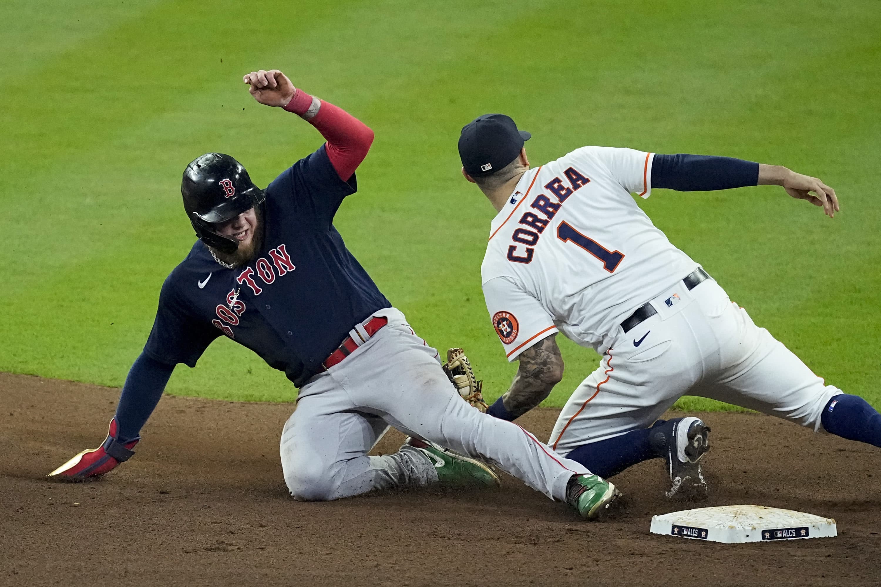 Houston Astros shortstop Carlos Correa tags out Boston Red Sox's Alex Verdugo at second to end the top of the seventh inning in Game 6. (Sue Ogrocki/AP)