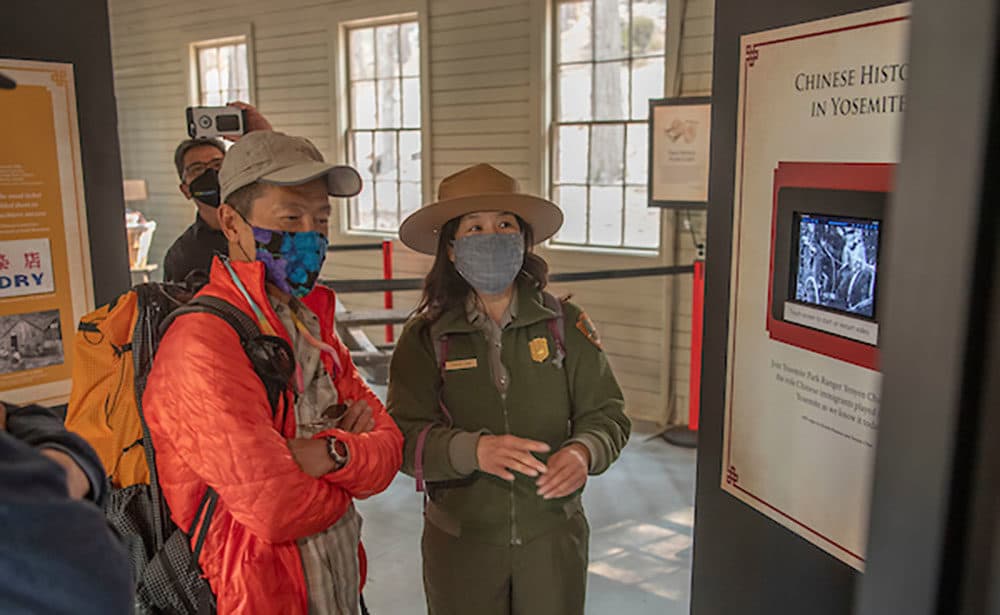 Park Ranger Yenyen Chan (right) interacting with park visitors in the new Chinese Laundry Building exhibit at the Yosemite History Center in Wawona. (National Park Service)