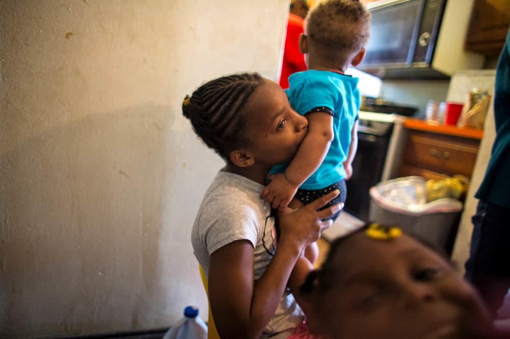 A young Dasani caring for her little sister, Lele. (Ruth Fremson/The New York Times)