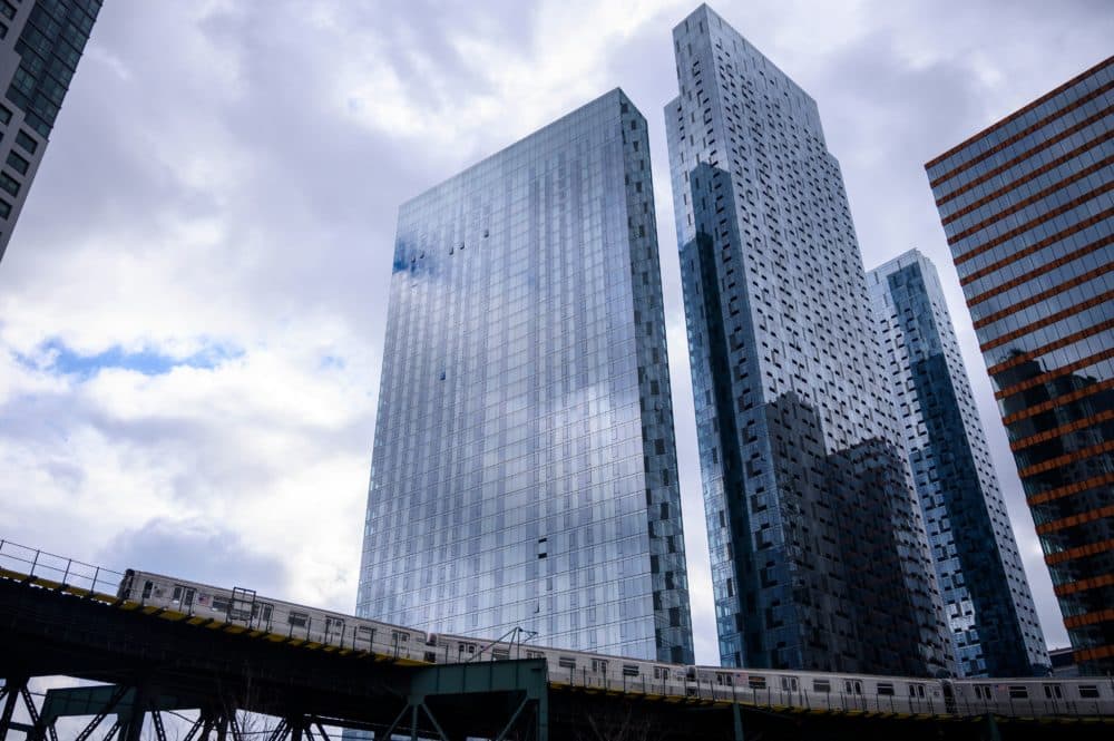 A subway is seen in front of skyscrapers in Long Island City in the Queens. (Johannes Eisele/AFP via Getty Images)